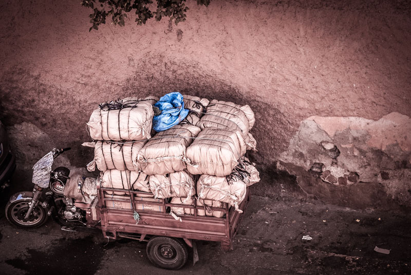Image of bundles being carried in a cart.