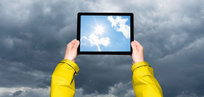 Child looking at a storm on a tablet