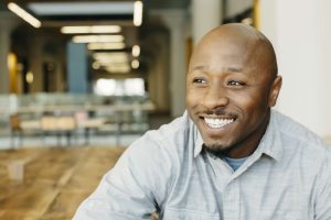 Businessman appears happy that he has been able to improve data accuracy