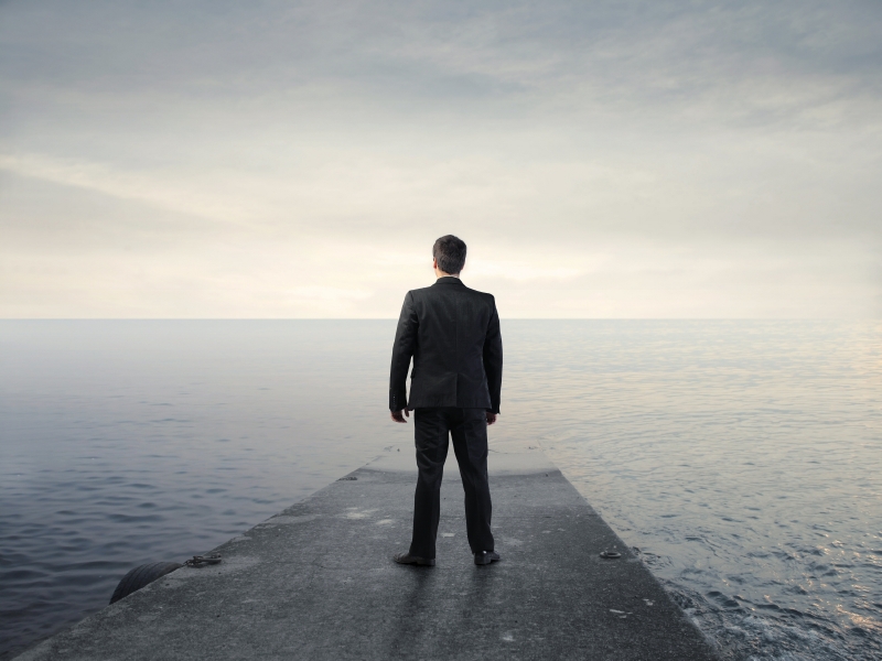 man thinking near water