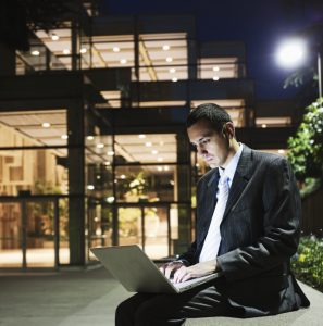 man working with data outside at night