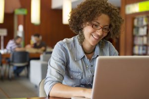 young woman with laptop studying agile development