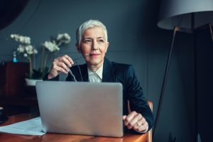 mature businesswoman considers two different types of MDM