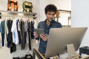 Male store owner tries to understand the data for omnichannel