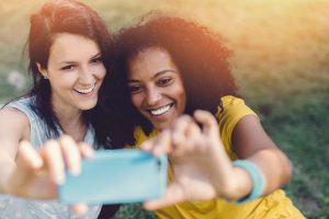 Young women taking a selfie, probably not considering if GDPR will shift focus on personal data