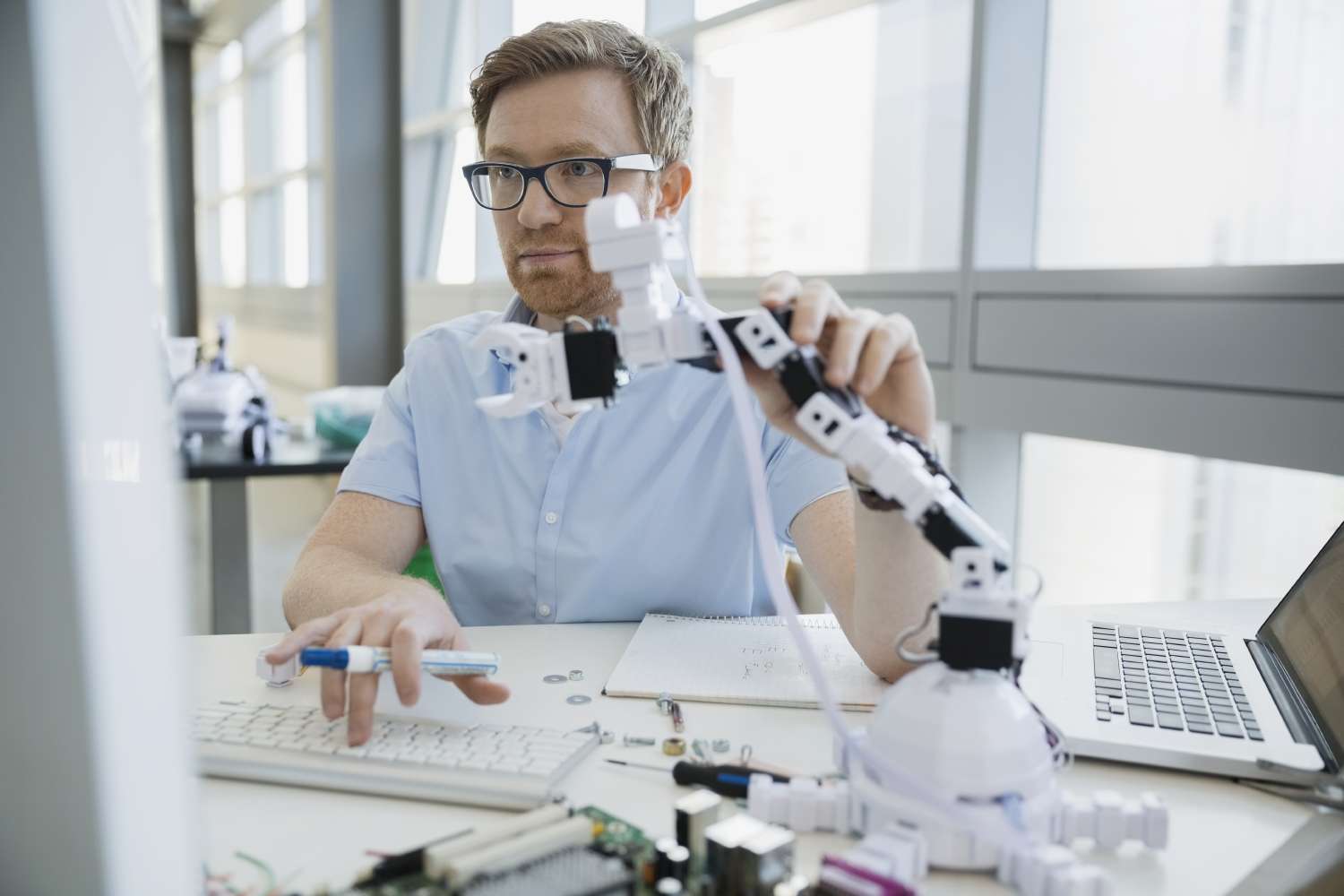 Man working with robotic arm working together with data as a decision maker