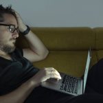 Man looking at COVID-19 graphs, learning terms