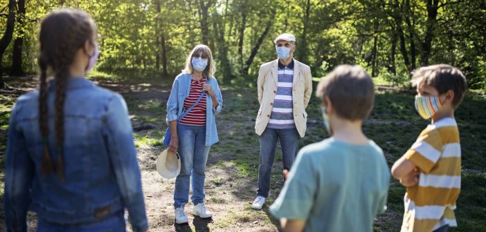 Family meets outdoors and socially distanced with masks during coronavirus