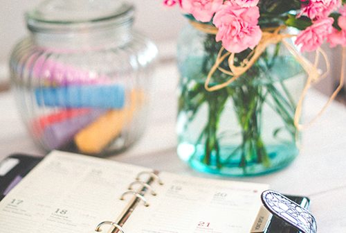 Planner and Flowers on Desk
