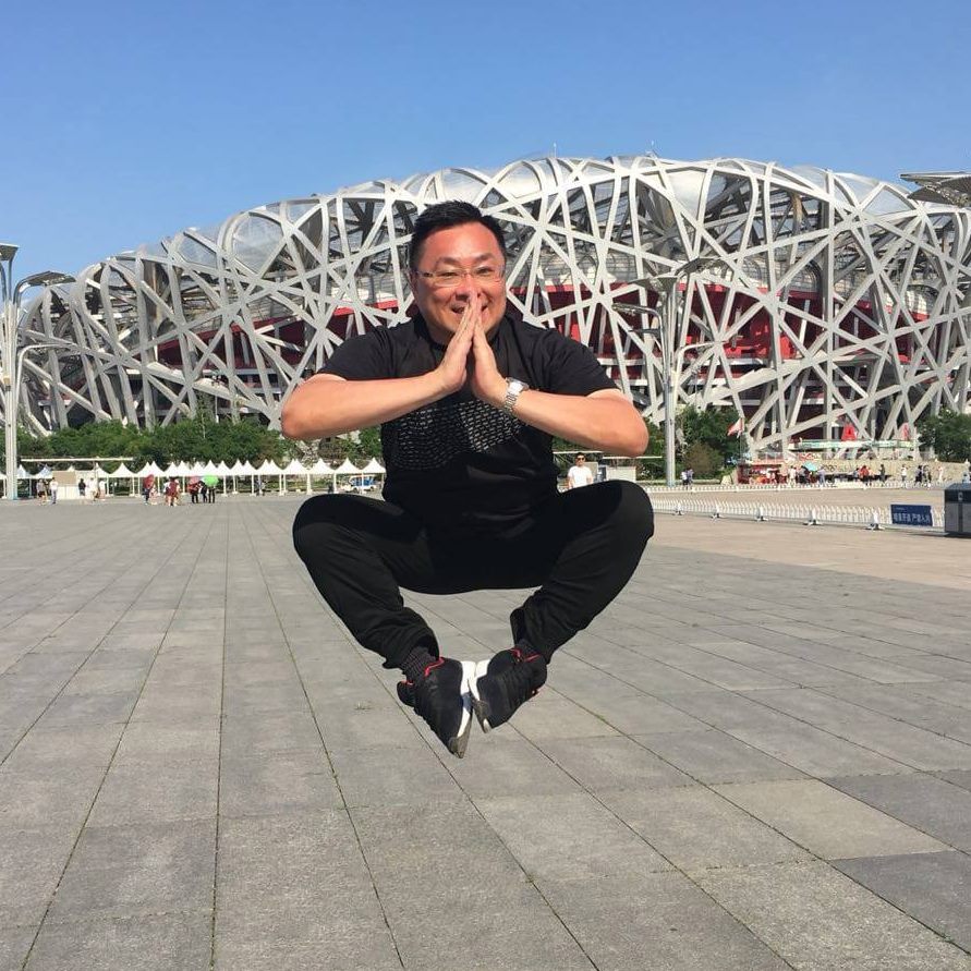 Keith jumping in front of an art structure