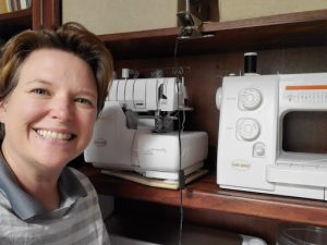 Catherine poses with her sewing machines