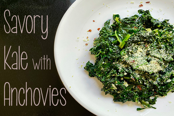 sauteed kale topped with parmesan cheese on a round white plate