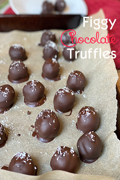 tray of chocolate coated truffles on parchment paper