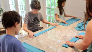 Kids making t-shirts into masks