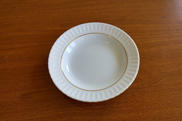 empty white plate on wooden surface