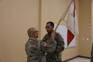 Captain Mobley, Company Commander, Headquarters and Headquarters Company, 206th Regional Support Group receives guidon from Group Commander, Colonel Santiago, 206th Regional Support Group. 