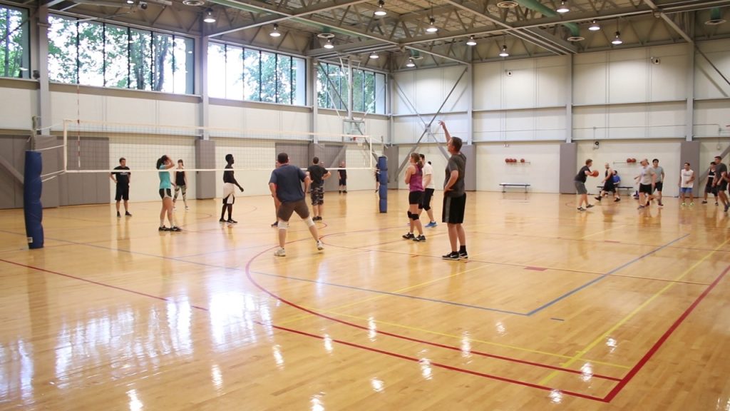 Employees play indoor volleyball