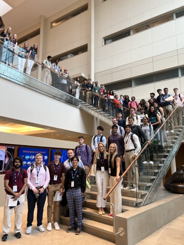 SAS interns stop for a photo on a staircase at SAS Headquarters