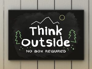 Think outside no box required on black board. Green and travel concept.