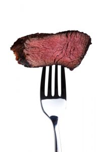 Bite of steak on a fork