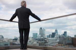 Man in suit overlooking city landscape