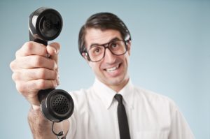 Man holding up an old fashioned phone 