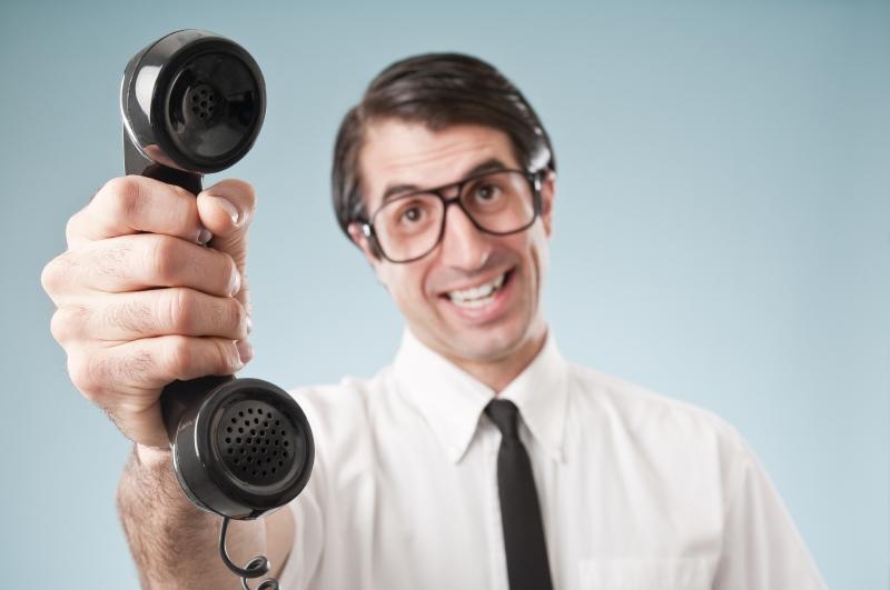 Man holding up an old fashioned phone