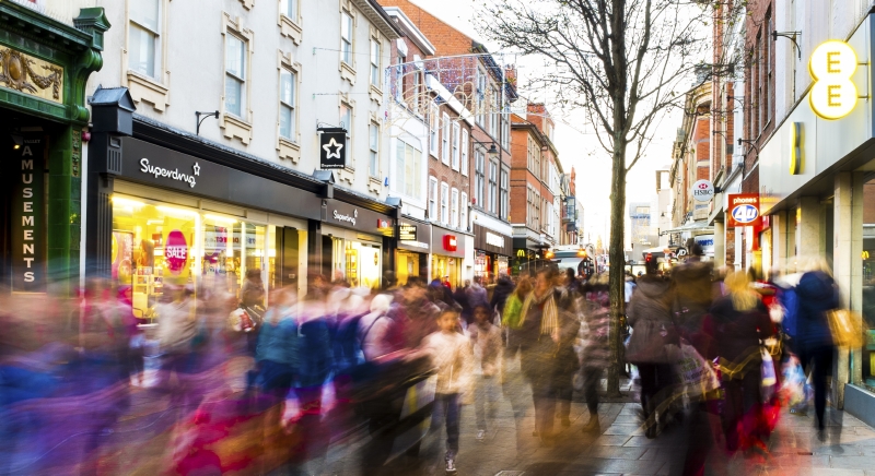 Blurry people walking on city street