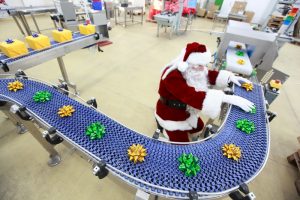 Santa working on gift wrapping assembly line