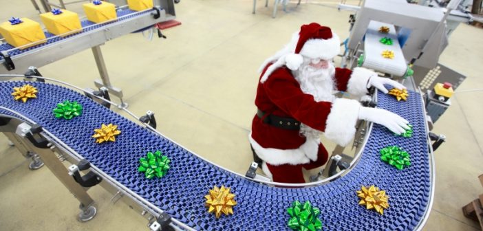 Santa working on gift wrapping assembly line