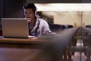 young man at laptop in library