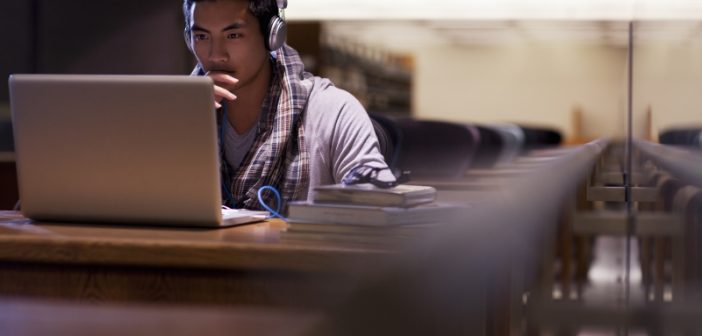 young man at laptop in library