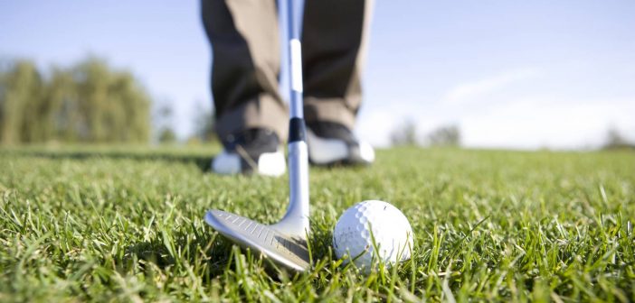 closeup of golf club and golf ball