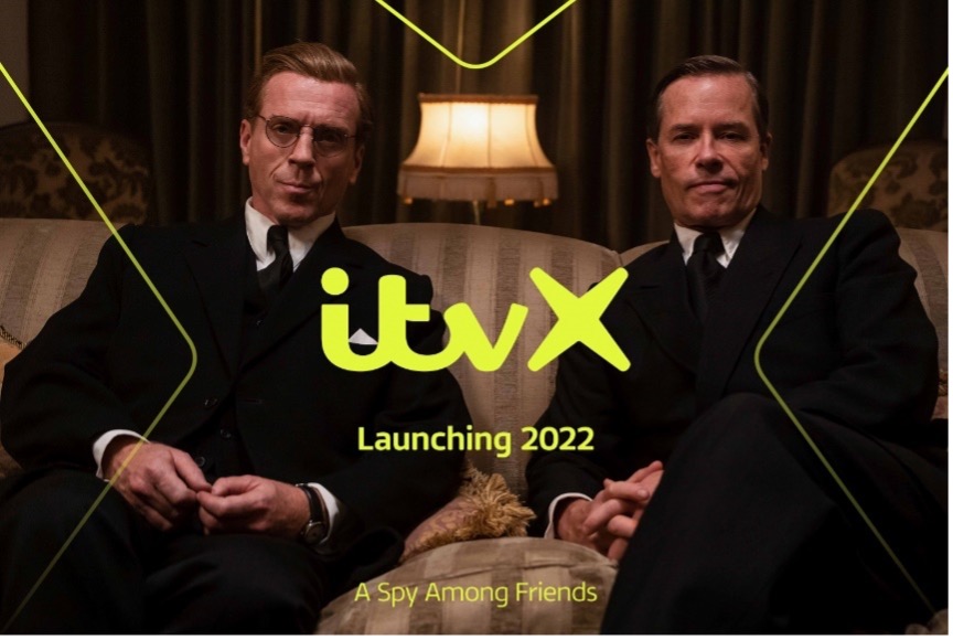 two men in suits sitting on a posh couch promoting itv