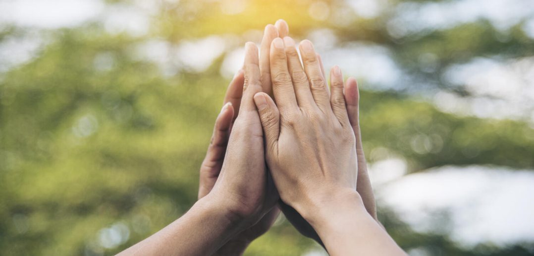 Teamwork high five as team together hands air greeting power tag team. Group of diversity people multiethnic