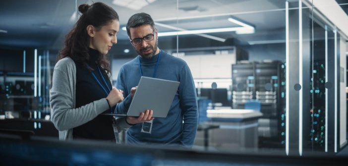 AI can make fast decisions – but can you trust them? Portrait of Two Female and Male Engineers Using Laptop Computer