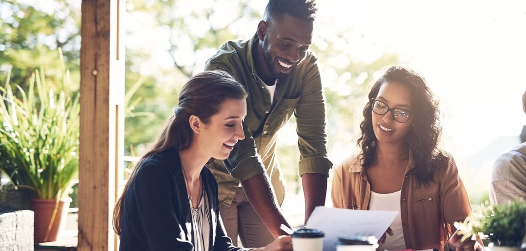 Happy people, documents and discussion with coffee in meeting for project planning at restaurant. Young group of creative employees with smile, paperwork or budget for startup at indoor shop or cafe.