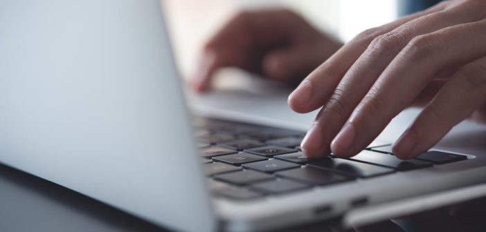 Close up of business woman hands typing on laptop keyboard on table, online working from home office, searching the information on internet network, e-learning, telecommuting concept