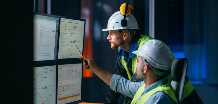 Group of operators control process on product line uses industry 4.0 and digital technology on modern factory. Two engineers follow assembly process uses SCADA system which AI technology and UI