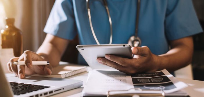Medical technology concept. Doctor working with mobile phone and stethoscope in modern office