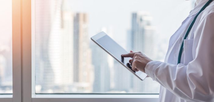 Telemedicine by medical doctor or physician consulting patient’s health telehealth online using mobile tablet in hospital for professional digital emergency tele-healthcare assistance service